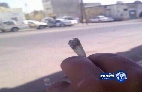 مغردون يتناقلون صورة لشخص يمسك بسيجارة "حشيش" أمام الدوريات في تبوك